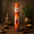 Hem Spiritual Life incense sticks with a Buddha statue, lit candle, and plant on a wooden surface.