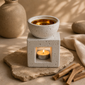 White ceramic oud wood and Palo Santo burner lit on a stone tray