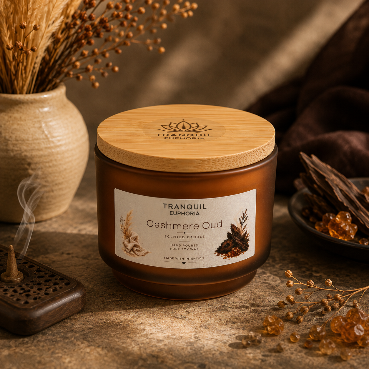 Cashmere Oud soy wax candle with a bamboo lid in an amber glass vessel