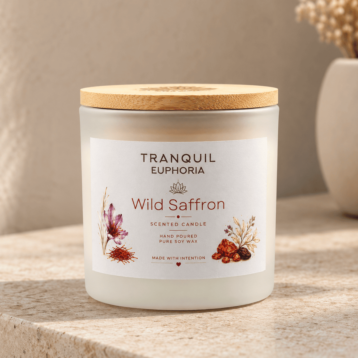 A Tranquil Euphoria 'Wild Saffron' scented candle in a frosted glass jar with a light wood lid, displayed on a stone surface with a neutral background.