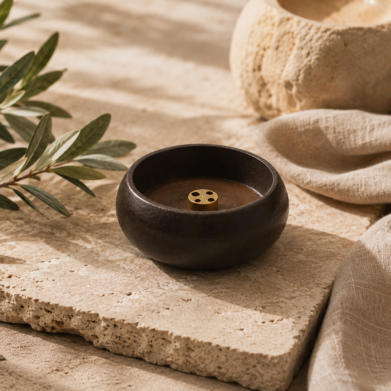 Minimalist wooden incense burner shown empty on a stone tray